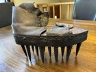 ​Old leather boot with long metal spikes