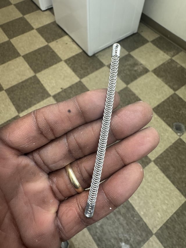 ​Found in public laundry room. Tightly coiled metal loops thing.