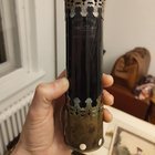 ​It is a metal capped dark red glass cilinder with an inscription, weights about 300 grams.