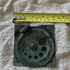 ​Metal, probably copper, rotates to different sized holes