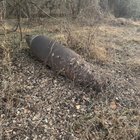 Rusted metal, large 5 ft long, seemingly hollow object in the shape of a tapered cylinder, letters “DAME-“ visible on front. found off a path in SE PA