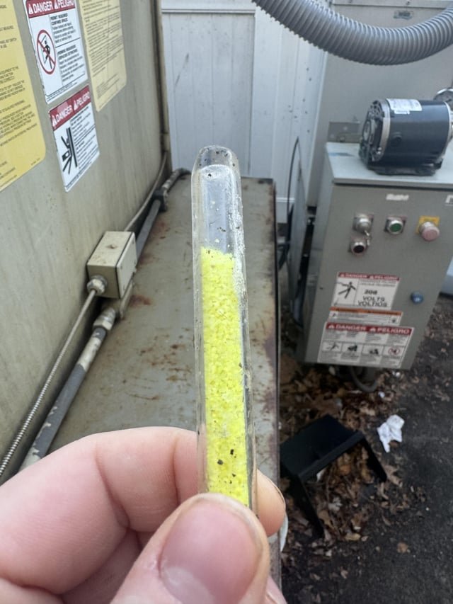 ​Thick Glass Cylinder filled with bright yellow crystalline substance found near the trash compactor at my gas station.