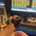 ​What is this small plastic plate with a little nub on the end and a elasticated strap on the other side.