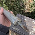 ​Found this underneath my car in my driveway. Car still drives fine. Long, silver metallic tube with a screw in one end and a crank looking thing on the other. Weighs about 13 oz.