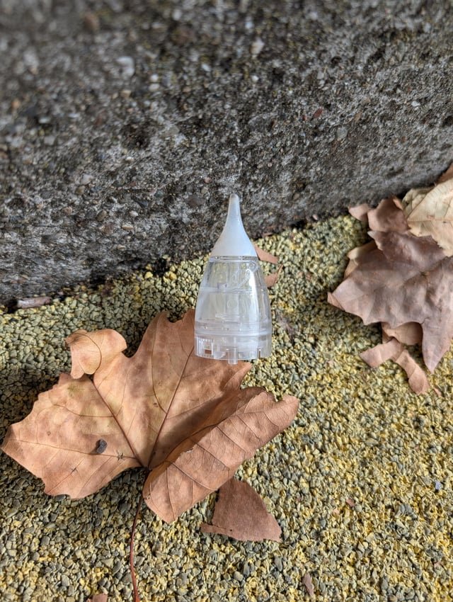 ​Clear plastic with soft silicone tip and opaque white fluid found in a park