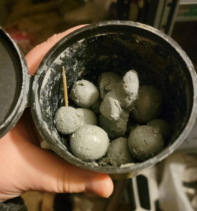 Foul smelling gray balls that look like clay. Found in marijuana container also containing a toothpick.