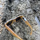 What is this small black plastic device taped to the inside of these sunglasses? Could be electronic but did not check the inside of it. Found by the Thames in London.