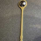 Found In Kitchen Drawer: About 12 inches, yellow, has half dome metal piece at the end and is made of plastic.