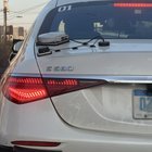 Round object with electrical wires attached to the back of a car