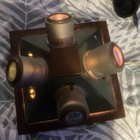 Wooden based metal pyramid type object with light and lenses. Each side has a different label and adjustment levers etc.