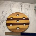 Round board with seven holes, made of different woods