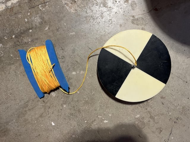Possibly a sailing tool? Fairly heavy, about 8 inch diameter disk