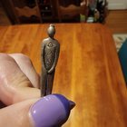 Small metal man with triangle markings, found in my change dish at home. Is this thing blessing or cursing my home?