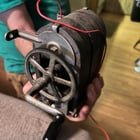What is this handheld machine with a crank and wires coming out of the back we found in a shop in rural Alabama – it’s super heavy.