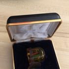 ​Small electronic gadget, 1 inch maximum in size, cast in clear resin, came with its padded case, found at a flea market