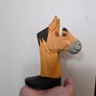 ​Reason for this lobotomomized horse?? Small wooden carved painted horse missing his brain. Found at a thrift store among the knick knacks for 2 bucks. Too light to hold a phone or book, does not have a hole in the base so impossible to hang