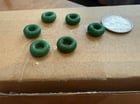 ​I found 6 of these green, rubber, Cheerio sized, donut shaped things in my cat’s toy where the catnip is supposed to go. They don’t stretch that much and are very lightweight.