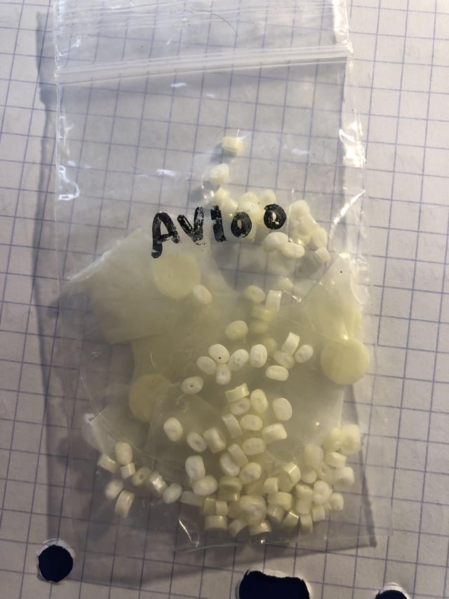 Small, offwhite, offround, little hole in center, found in france, next to a mcdonalds, smells minty, flat circle pads inside too