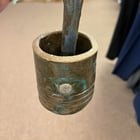 ​What is this ceramic assembly with a cup that swings on a two-pronged arm?