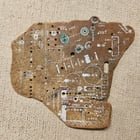 A sea-circuit board found washed up on a beach in Okinawa. About 8-9cm across at its widest.