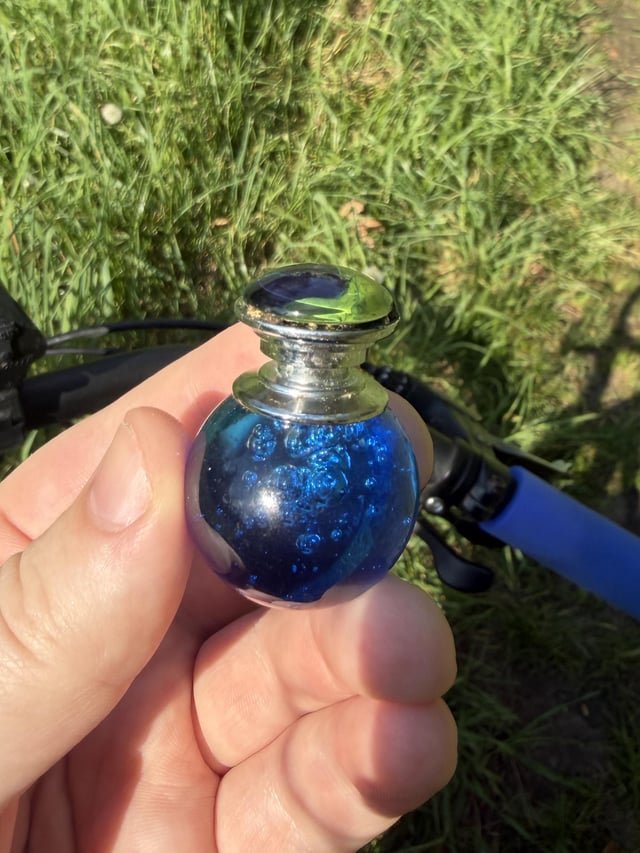 What is this blue glassy orb with a metal knob on top?
