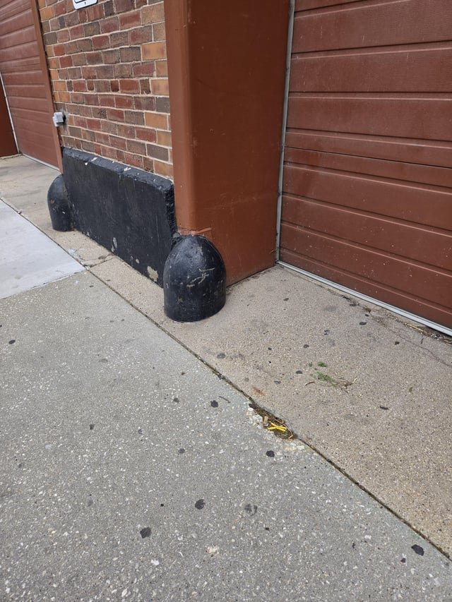 What are these black round bumps place at the bottom of some Chicago buildings