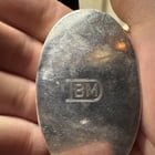 ​My friend picked up this silver medallion thing, what could it be? It has an IBM (or DBM?) logo, a sterling silver stamp, and can open up to some cardboard stored inside. Weighs a few ounces, about the size of my palm
