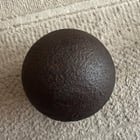 Large iron ball, 23kg, 18cm diameter, magnetic, flat spot to one side, pronounced cast seam with sprue mark on the seam