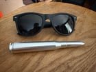 ​Metal, silver, munitions-like object with threaded ends, removable tip. 5.5 inches, 69 grams